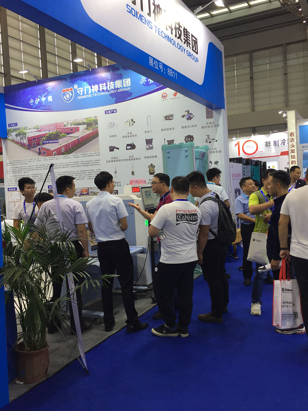 我（wǒ）司參（cān）展工作人員為觀展者介紹安檢機安（ān）檢門